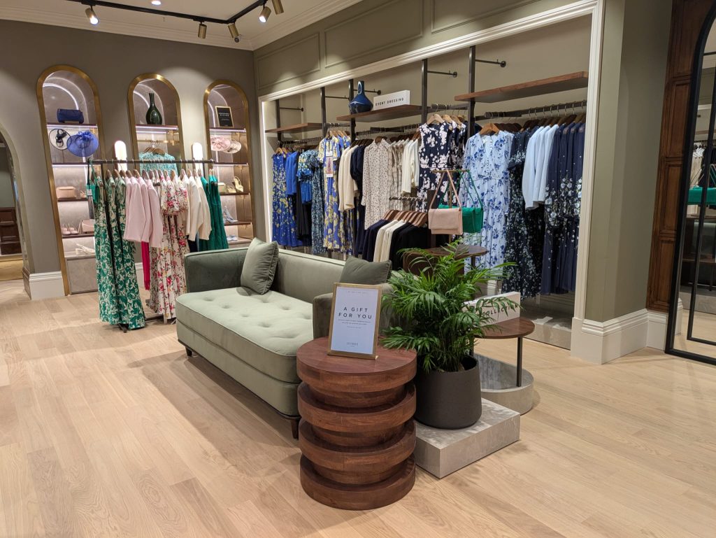 Womens clothes and sofa in new store